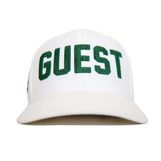 Front view of a classic white Country Club GUEST hat with green embroidered lettering