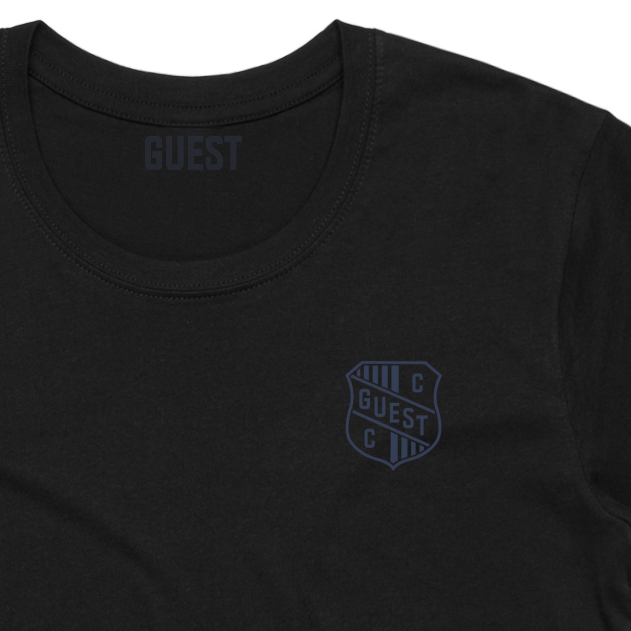 Close up of Black Country Club GUEST t-shirt featuring small crest logo on left chest