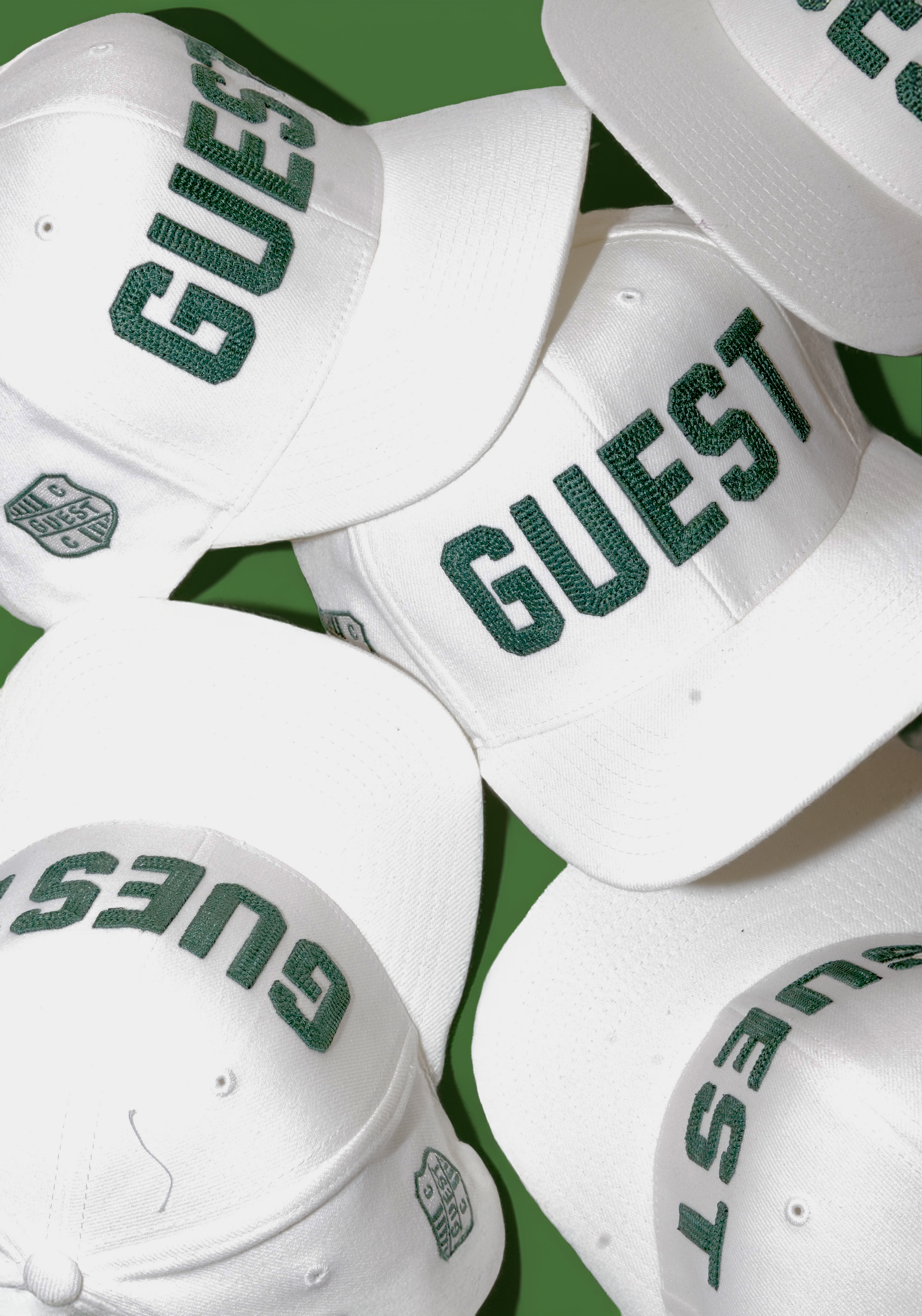 Collage photo of classic white Country Club GUEST hats with green embroidered lettering