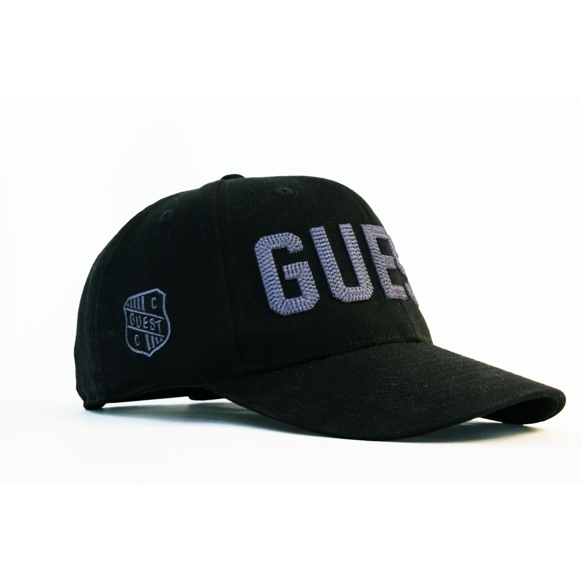 Side profile of twilight Country Club GUEST golf hat with blue embroidered lettering and blue shield logo