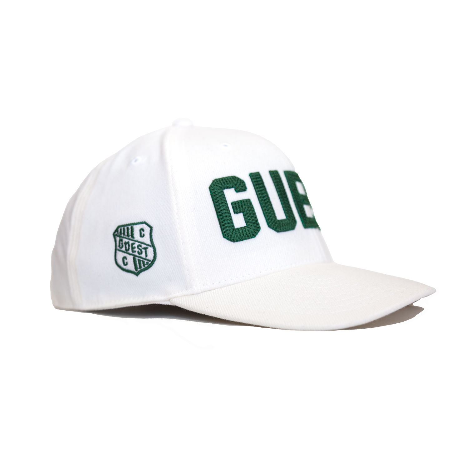 Side view of a classic white Country Club GUEST hat with green embroidered lettering