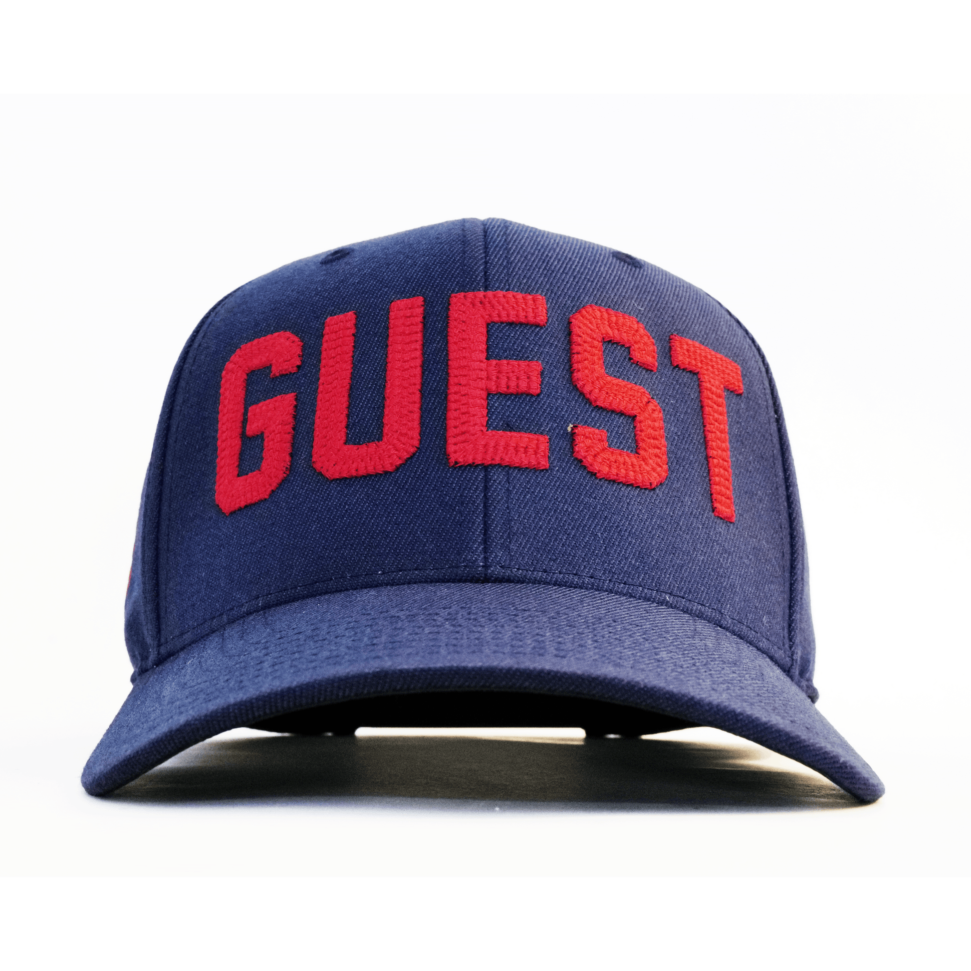Front view of a navy Country Club GUEST hat with bold red embroidered lettering