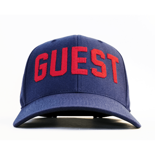Front view of a navy Country Club GUEST hat with bold red embroidered lettering